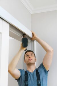 door repair contractor is fixing the slding door operator track